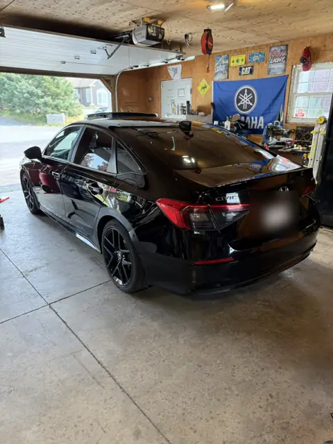 Black sedan, foam wash and gloss finish