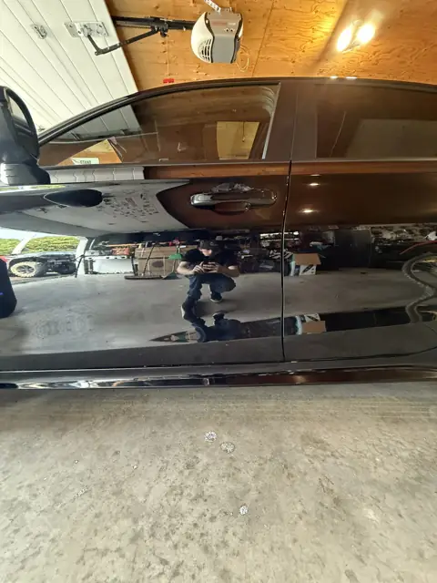 Black sedan, foam wash and gloss finish